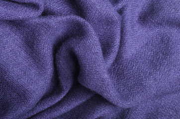 Fototapeta na wymiar The texture of warm knitted lilac linen. Close-up.