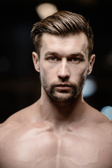 Obraz premium sexy strong bodybuilder athletic men pumping up muscles with dumbbells