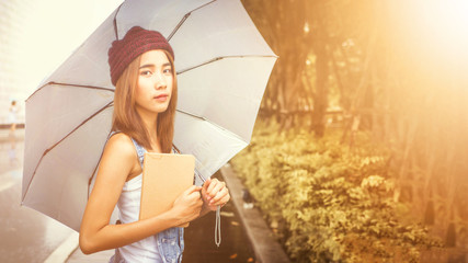 beautiful young Asia woman with reading book at outdoor garden.