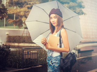 beautiful young Asia woman with reading book at outdoor garden.