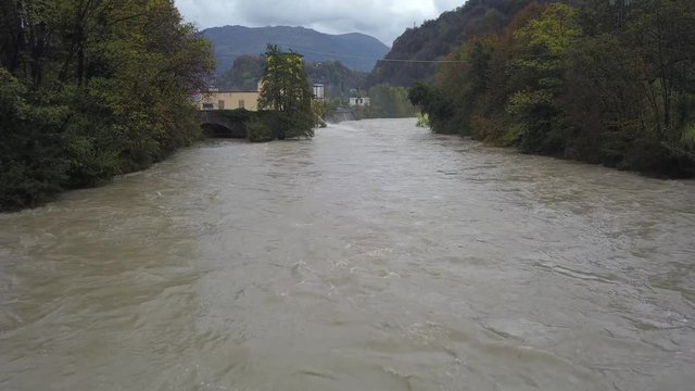 Drone aerial view of the Serio river swollen after heavy rains. Province of Bergamo, northern Italy