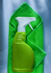 Green washing rag sprayer on white background
