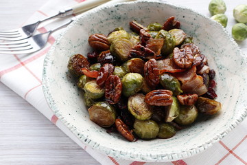 Traditional warm salad at Thanksgiving. Brussels sprouts, onions, bacon, cranberries and pecans.