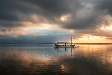 Traditional balinese  fishing boat at sunrise,   Sanur,  Bali, Indonesia