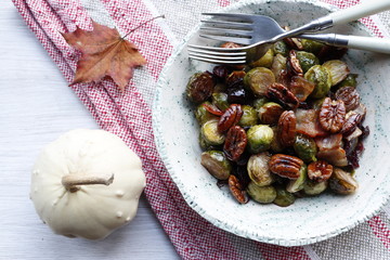 Traditional warm salad at Thanksgiving. Brussels sprouts, onions, bacon, cranberries and pecans.