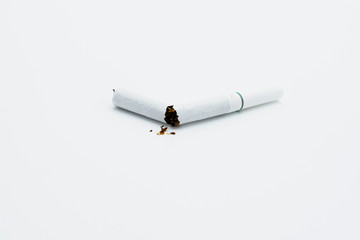 Broken white cigarette on an isolated white background