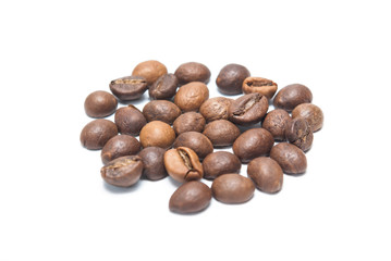 Roasted coffee beans sprinkled on a white background