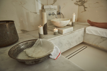 Laconic image of the Turkish bath interior with the legs of the visitor in the background
