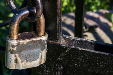 Metal padlock on fence close-up
