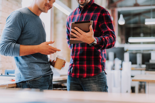 Experts in field of graphic design are looking through necessary material for work while using laptop