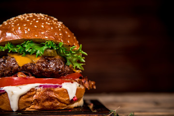 Tasty burger on wooden table.