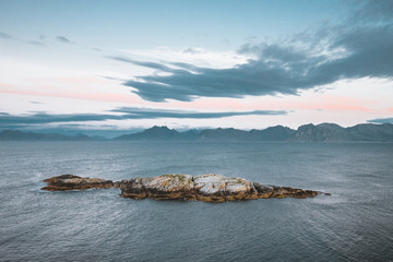 Sunrise and Sunset at Henningsvaer, fishing village located on several small islands in the Lofoten archipelago, Norway over a blue sky with clouds.