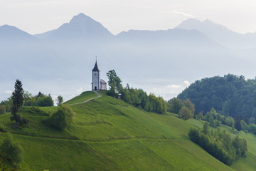 Spring mountain landscape in Slovenia, morning mist over the valley
