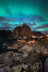 Northern Lights Aurora Borealis with classic view of the fisherman s village of Hamnoy, near Reine in Norway, Lofoten islands. This shot is powered by a wonderful Northern Lights show.