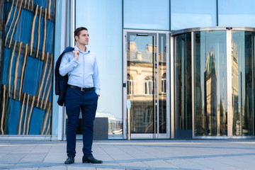 Serious young businessman is waiting for his partner to have deal