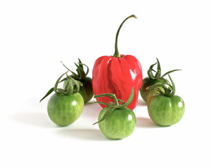 hot bell peppers and green tomatoes on white background