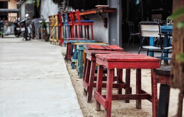 Fototapeta na wymiar old multi-colored stools, red, blue, yellow..