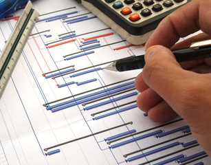 close up of engineer working on time chart diagram, construction project gantt diagram