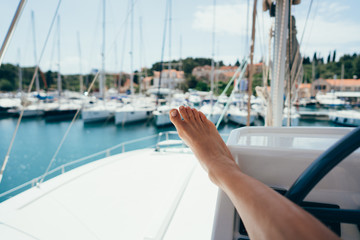 Female foot in the background of a moored yacht