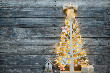 christmas wooden tree natural decoration ornament and copyspace on old wood board