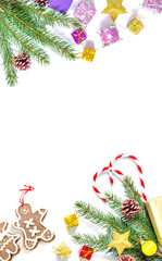 Branch of a Christmas tree with balls, fir cones, traditional candies and boxes with gifts isolated on a white background. Christmas and New Year background with free space for text.