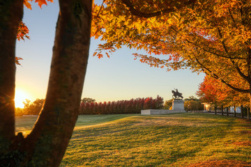 October 20, 2018 - St. Louis, Missouri - The sunrise and fall foliage around the Apotheosis of St. Louis statue of King Louis IX of France on Art Hill in Forest Park, St. Louis, Missouri.