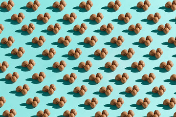 Background made from walnuts on the blue background
