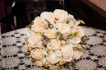 White roses wedding bouquet on the table