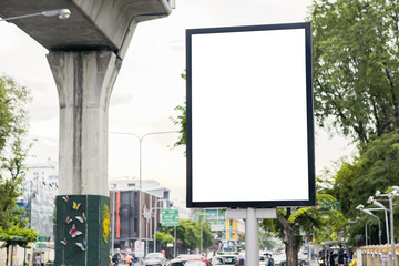 blank street billboard in urban road city area with skytrain rail line in the background , isolated...