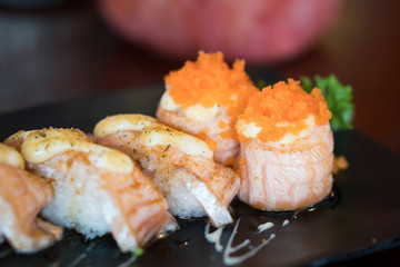 Fresh Salmon Sushi on Black Japanese plate