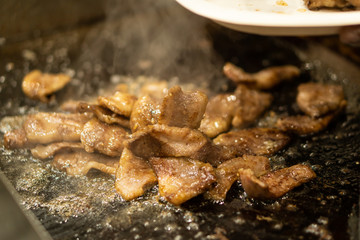 Japanese chef cooking wagyu beef with sauce in the kitchen to serve gourmet restaurant meal, delicious grill meat
