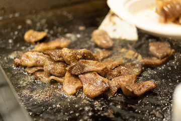 Japanese chef cooking wagyu beef with sauce in the kitchen to serve gourmet restaurant meal, delicious grill meat