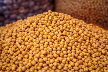 Heap of spicy salty hazelnuts exposed for sale on the farm market. Closeup, food photography.