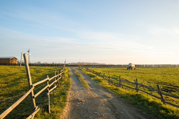 Fototapeta na wymiar The path to the farm at the Sunset in Velka Lhota along a wooden fence
