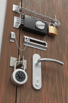 Safety and security concept. Door with many locks. 3D rendered illustration.