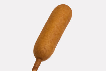 An isolated corn dog at an angle on white background.
