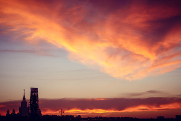 Naklejka na ściany i meble Big metropolis against the backdrop of a beautiful sunset in the fall.