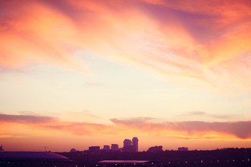 Big metropolis against the backdrop of a beautiful sunset in the fall.