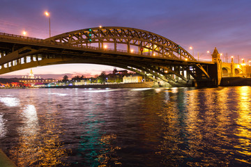 The long beautiful bridge across the river in the evening.