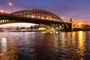 The long beautiful bridge across the river in the evening.