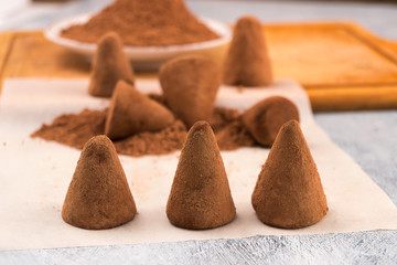 Sweet dessert - chocolate candy truffles with cocoa powder.