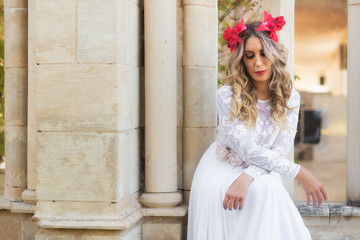 Fototapeta premium Portrait of beautiful blond girl in medieval dress with red diadem. Fairy tale scene