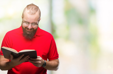 Young hipster man wearing glasses and reading a book over isolated background with a happy face standing and smiling with a confident smile showing teeth