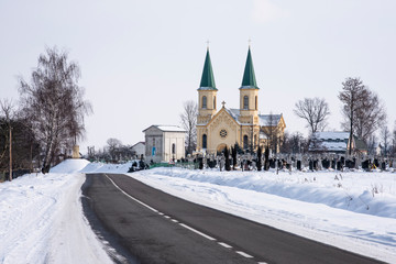 Fototapeta na wymiar Ancient temple, chapel and cemetery, Ukraine. Winter rural landscape
