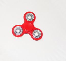 An isolated fidget spinner laying flat on a white background