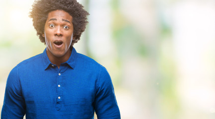 Afro american man over isolated background afraid and shocked with surprise expression, fear and excited face.