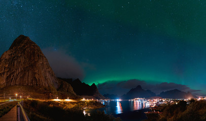 Northern Lights Aurora Borealis with classic view of the fisherman s village of Reine near Hamnoy in Norway, Lofoten islands. This shot is powered by a wonderful Northern Lights show.