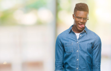 Young african american man over isolated background sticking tongue out happy with funny expression. Emotion concept.