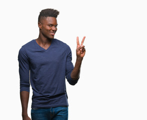 Fototapeta premium Young african american man over isolated background smiling with happy face winking at the camera doing victory sign. Number two.
