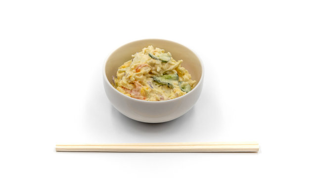 Japanese Potato Salad With Cucumbers, Carrots, and Onion isolated on the white and wooden chopsticks